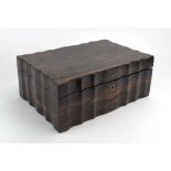 A 19th century coromandel work box of serpentine form, the lid opening to reveal a rosewood,