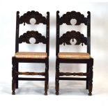 A near pair of 17th century-style carved oak hall chairs with mask and acorn decoration