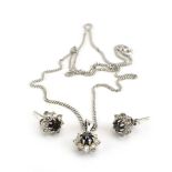 An 18ct white gold flat curblink necklace suspending a cluster pendant set black diamond in a