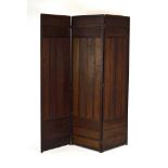A late 19th/early 20th century oak three-panelled folding screen