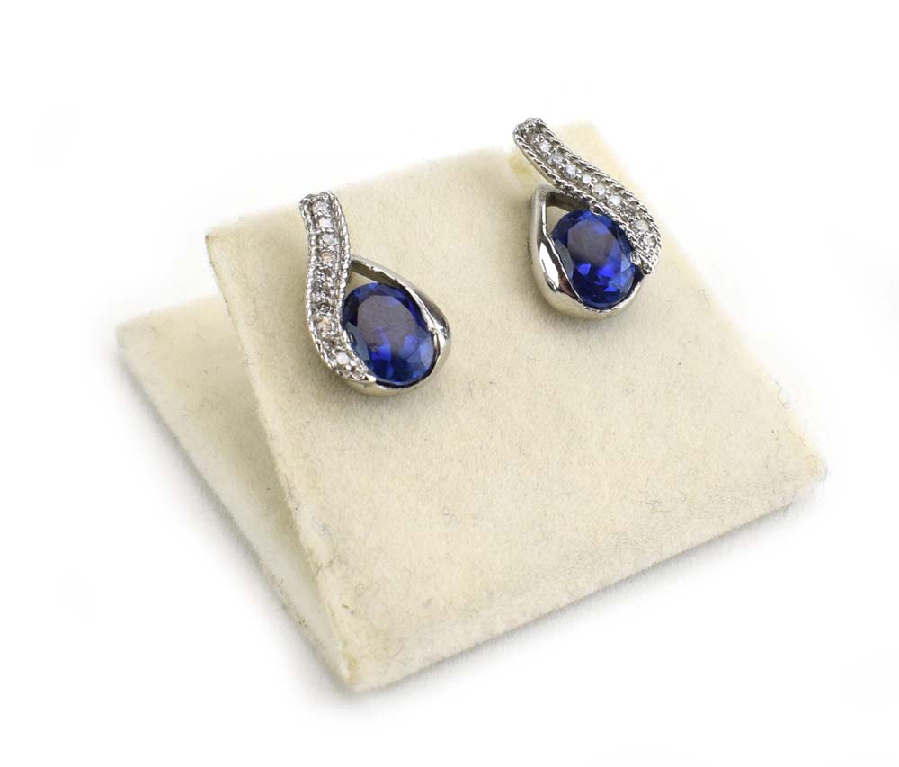 A pair of 14ct white gold ear studs of teardrop design set oval tanzanite and small diamonds, l. 1.