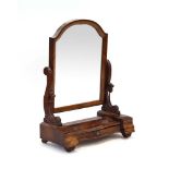 A Victorian mahogany swing mirror, the plate over a domed top,