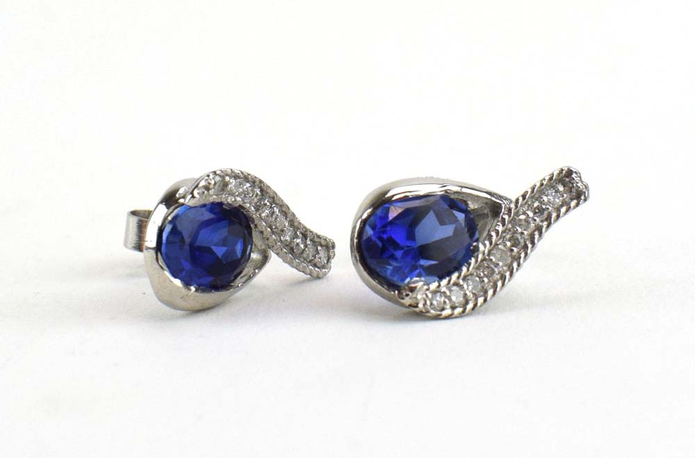 A pair of 14ct white gold ear studs of teardrop design set oval tanzanite and small diamonds, l. 1. - Image 2 of 5