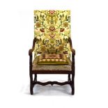 A late 17th century and later upholstered French walnut open armchair with an associated