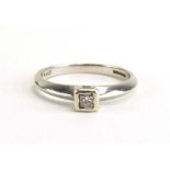 A 9ct white gold ring set princess cut diamond in a rubover setting, ring size O, 2.