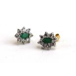 A pair of yellow metal ear studs, each set an emerald and paste cluster, l. 1.1 cm, 1.