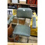 Green vinyl upholstered engineer's stool