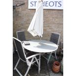 Metal and glass garden circular top table with 4 matching chairs and parasol