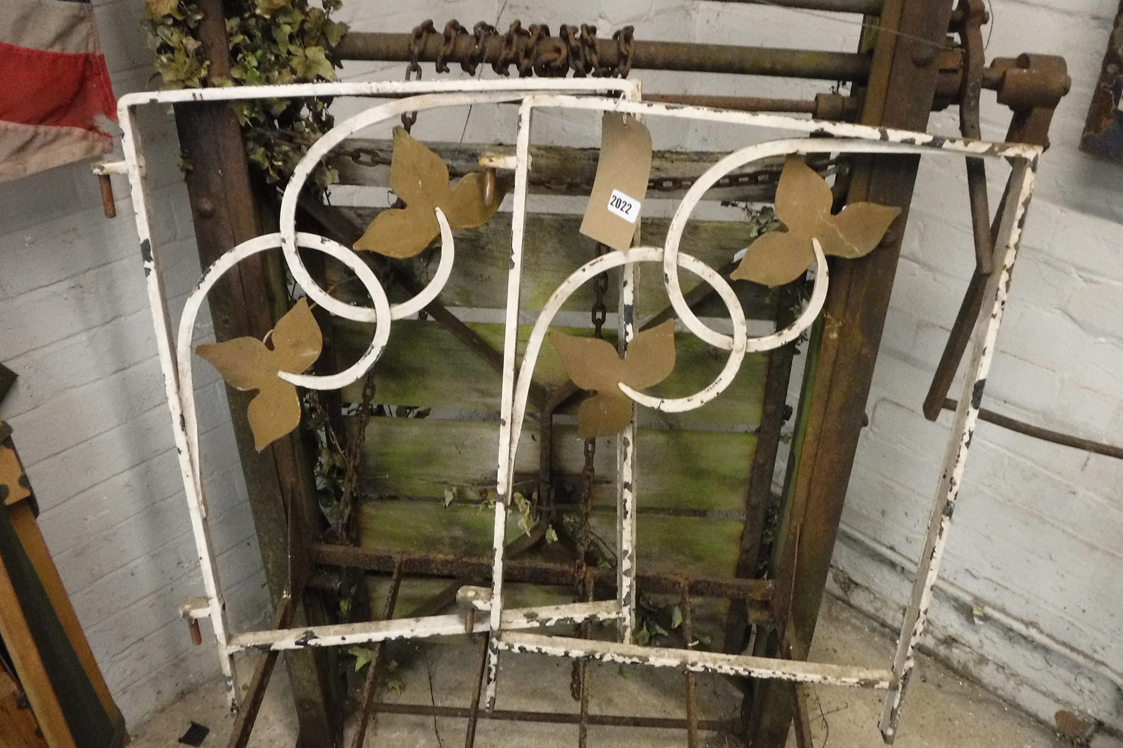 Pair of metal window frames with wrought iron floral motifs