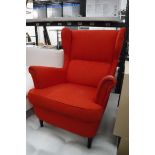 Red fabric wing back armchair