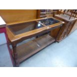 A rubberwood console table with glazed inserts