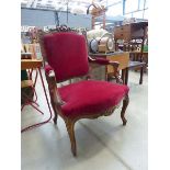 Carved armchair with maroon fabric