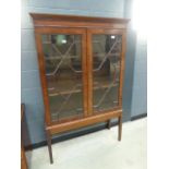 Glazed mahogany double door china cabinet on raised supports