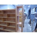 A narrow maple finish open fronted bookcase