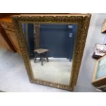 A rectangular mirror in a gilt frame