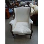 Arm chair with carved frame and cream fabric (collector's item, see soft furnishings policy)