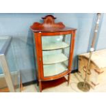 A bow fronted Edwardian china cabinet