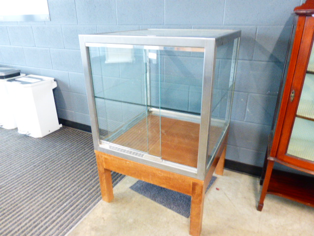 A glazed and chrome display cabinet on wooden base