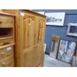 A pine double wardrobe with drawer under