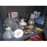 Cage containing loose cutlery, glassware and ornamental figures