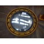 A circular convex mirror in a gilt frame and a pine toilet mirror