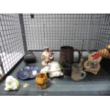 5610. Cage containing ornamental figures, a bell, camera and dishes