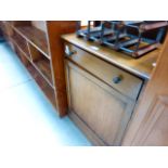 A beech single door cupboard with drawer over