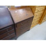 An Edwardian bureau with three drawers under