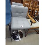 Pair of grey leather effect swivel chairs