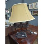 Ornate metal table lamp with cream fabric shade