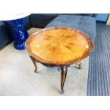 Circular walnut table with pie-crust rim