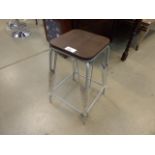 A metal and wooden stool