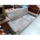 A brown suede three seater sofa