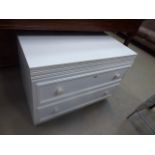 A white painted chest of two drawers