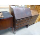 A reproduction mahogany bureau with three drawers under