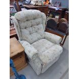 Green floral fabric reclining armchair