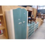 A cream and green painted bedroom suite comprising double wardrobe, dressing chest and chest of