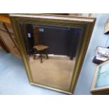 A rectangular mirror in a gilt frame