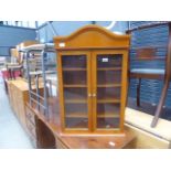 A glazed beech double door display cabinet