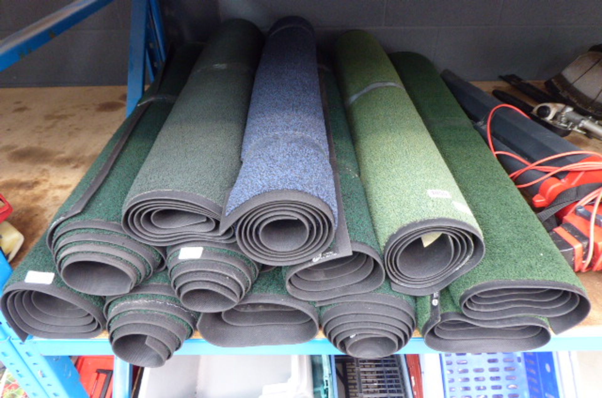 Large quantity of blue and green rubber backed mats