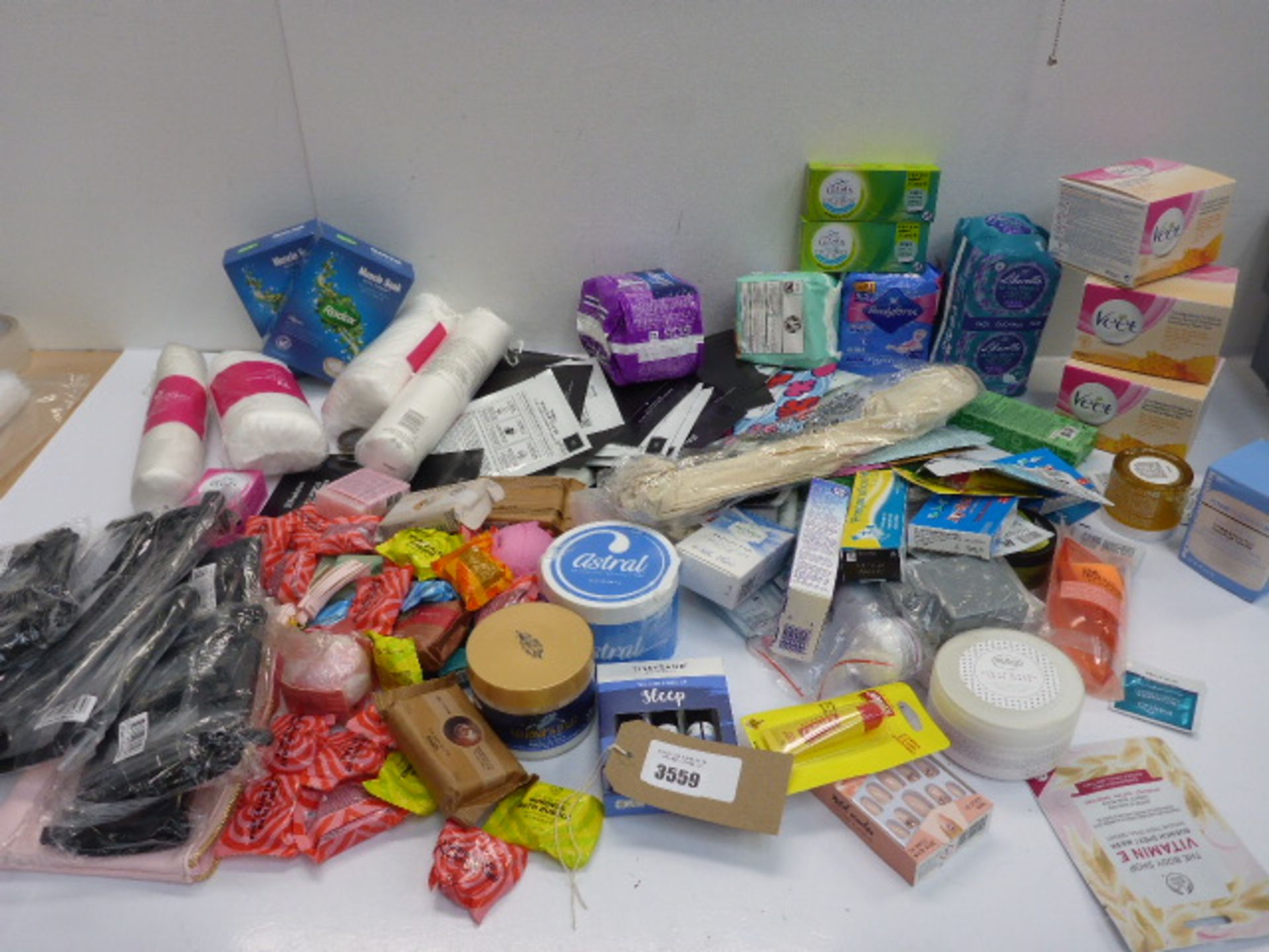 Bag of beauty products including muscle soak, Lil-ets, sanitary towels, Veet warm wax, bath bombs,