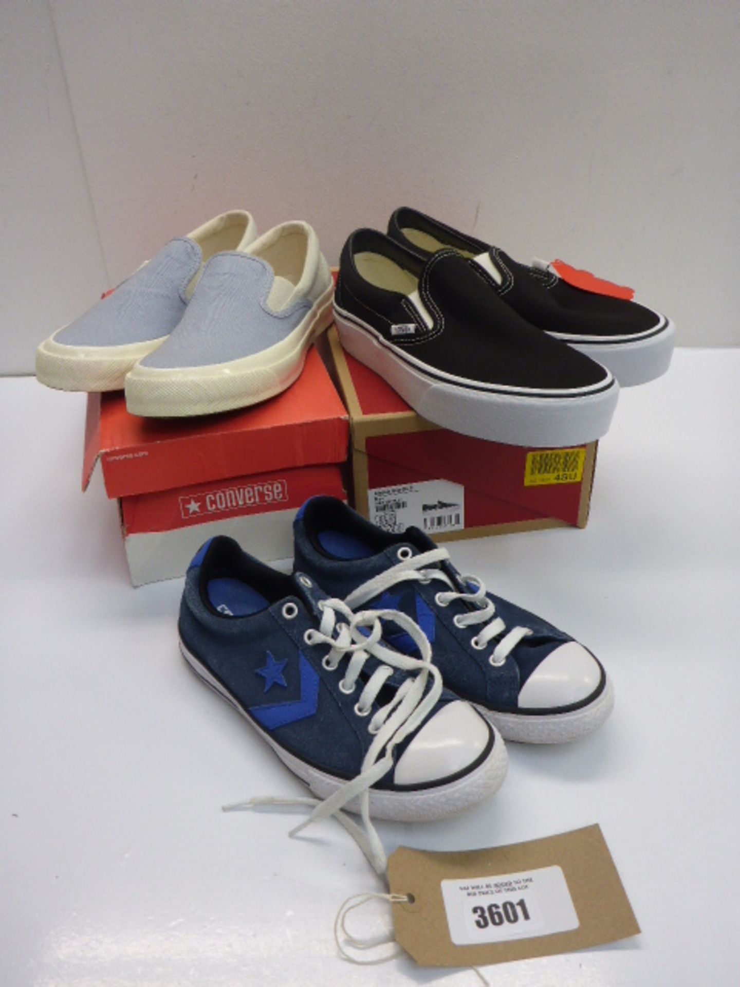 A pair of baby blue slip-on Converse UK 7, a pair of black slip-on Vans UK 7.5 and a pair of navy