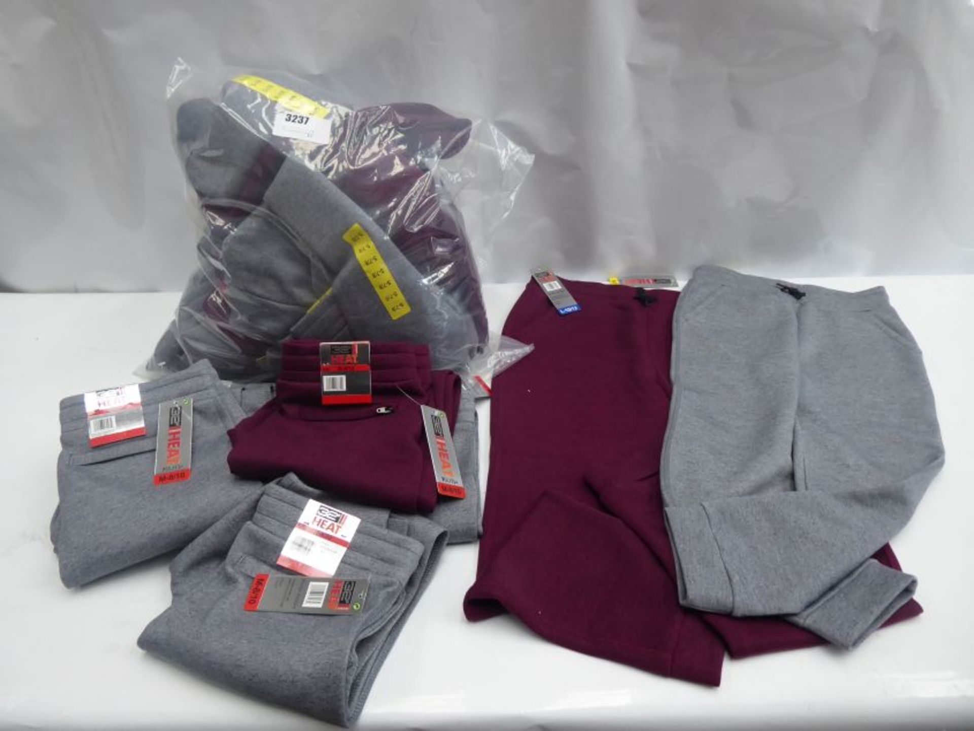 Bag containing 20 pairs of youth jogging pants by 32 Degree Heat in light grey and maroon, sizes