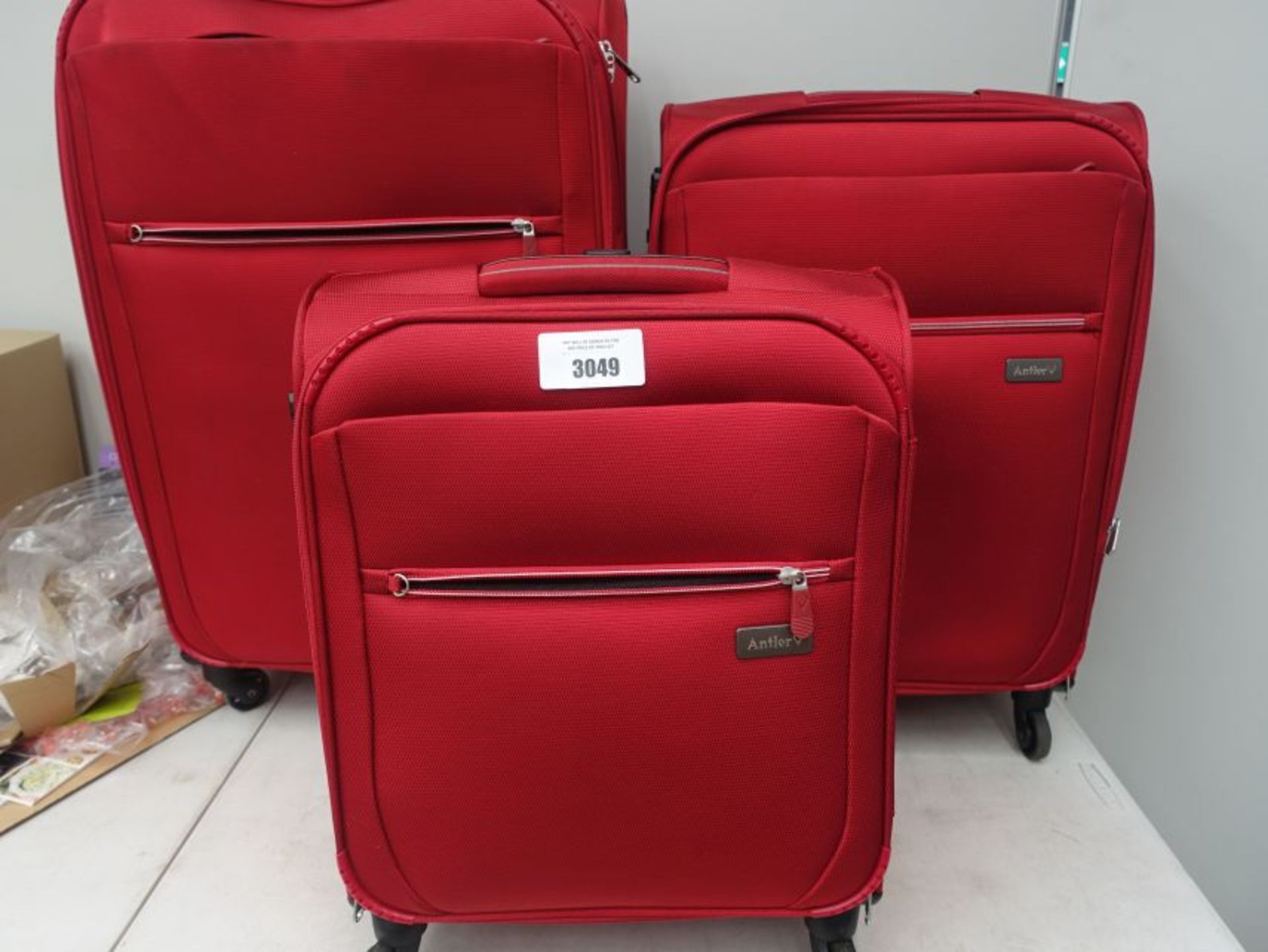 3 piece red fabric Antler suitcase set