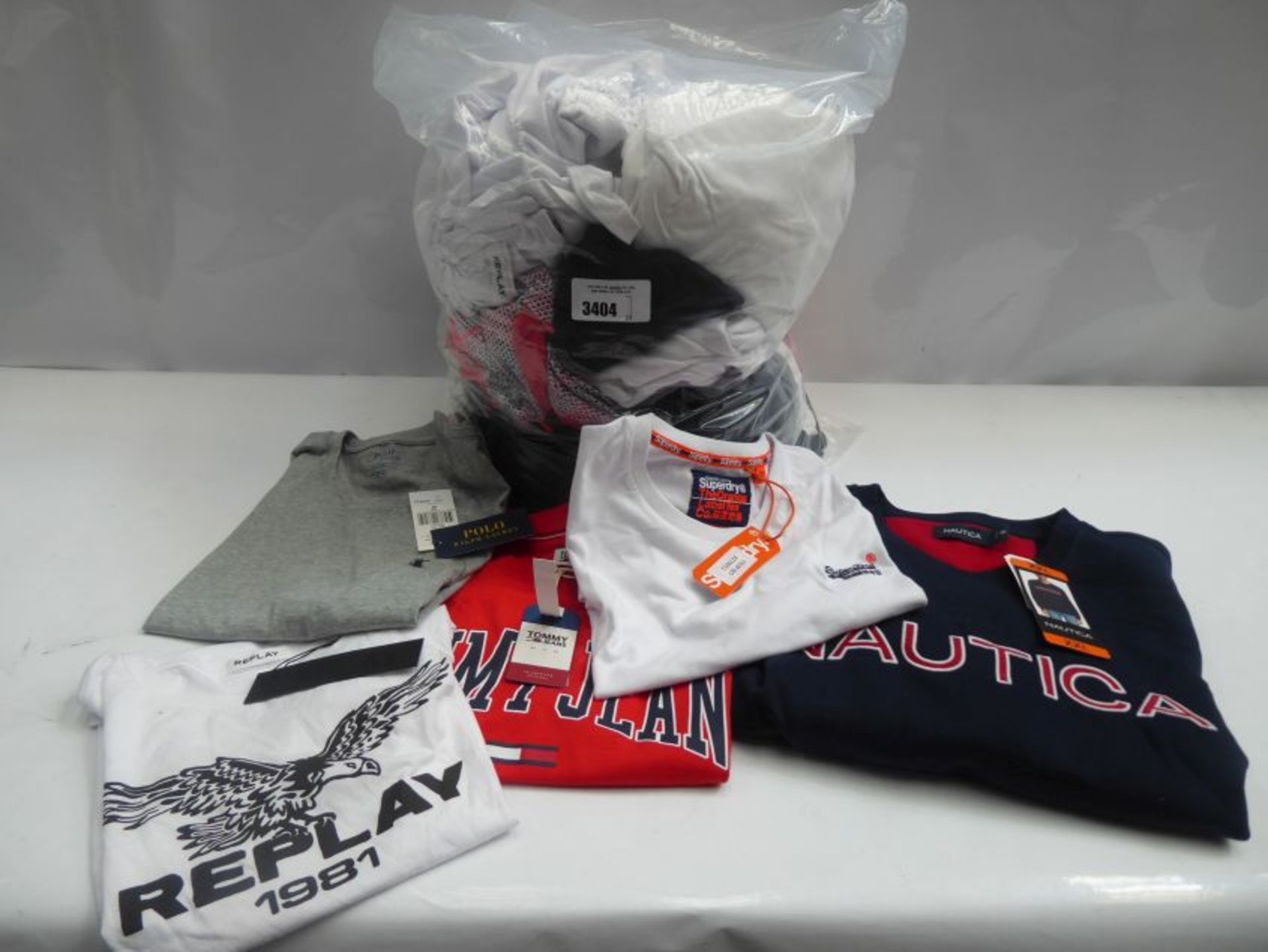 Bag containing mixed sportswear to include swimming trunks, polo shirts by Kirkland, t-shirts by