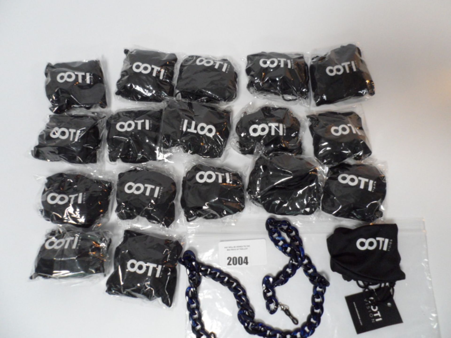 Bag of COTI Vision necklaces with bags in various colours.