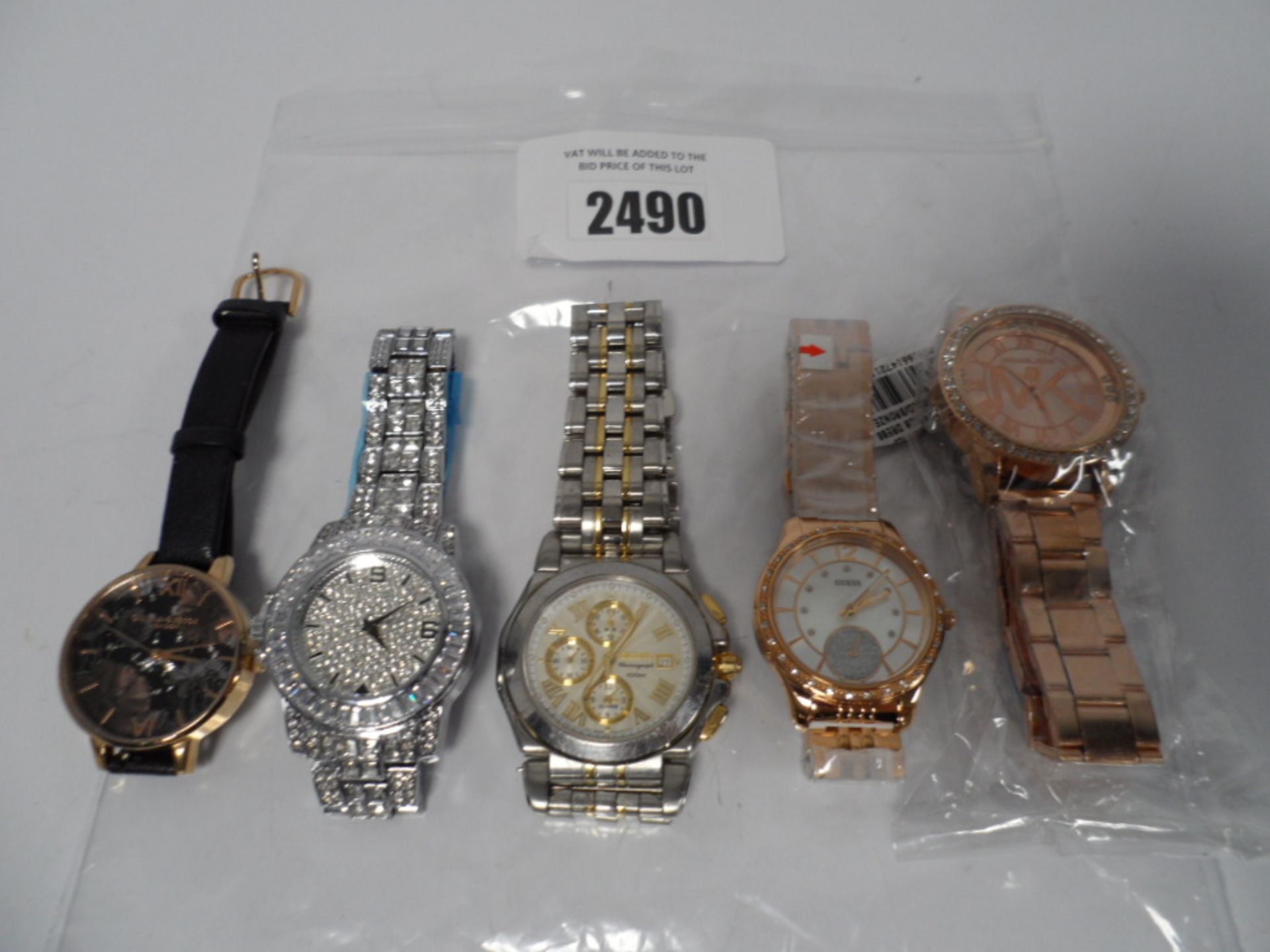 Bag of five loose watches including Sekio, Michael Kors, Guess, etc.