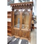 Heavily carved and glazed double door display cabinet