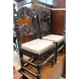 Pair of heavily carved oak dining chairs