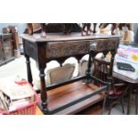 Carved oak sidetable with stretchers and frieze drawer